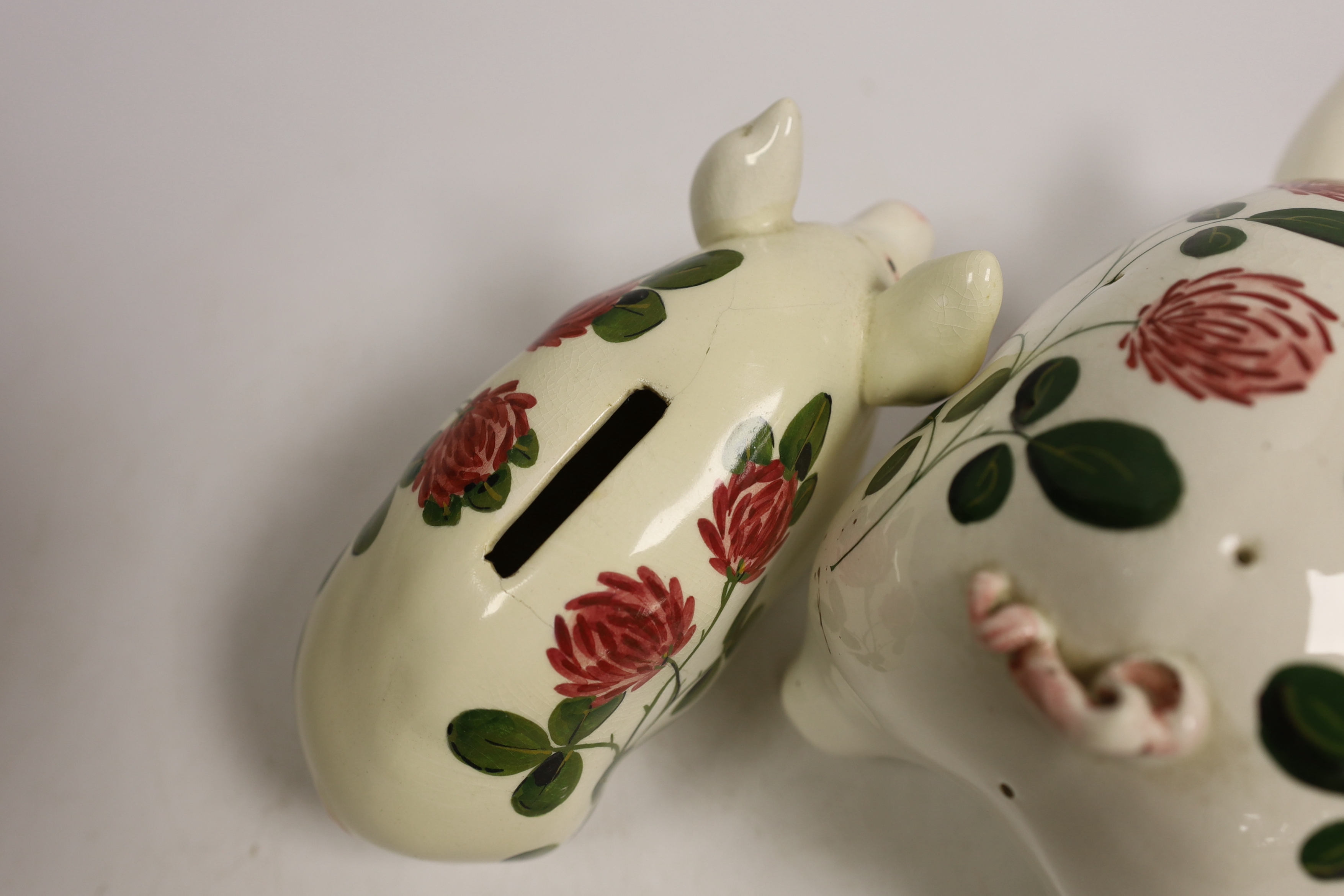 A Plichta rose decorated pig money box, 16cm, and a Plichta rose decorated hatpin holder pig, 23cm and two other Plichta pigs